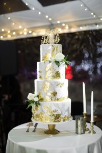 Gold covered wedding cake with spotlights on it