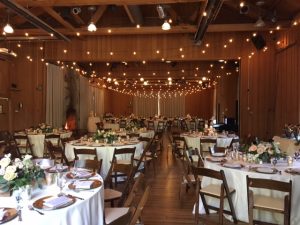 tables and chairs with lights above for utah weddings